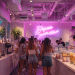 Bubble tea shop interior with customers drinking boba drinks and milk tea.