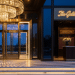 modern fine dining restaurant entrance design concepts with chandeliers, glass doors, and marble steps