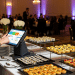 Professional caterers showing the benefits of a catering POS system at an event.