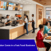 Fast food restaurant interior showing kiosks and staff reducing labor costs.